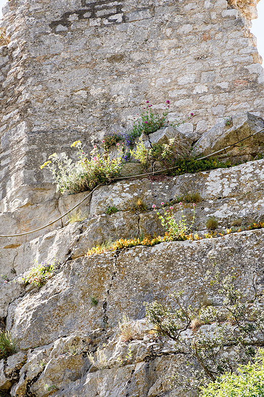 The rock wall behind the church