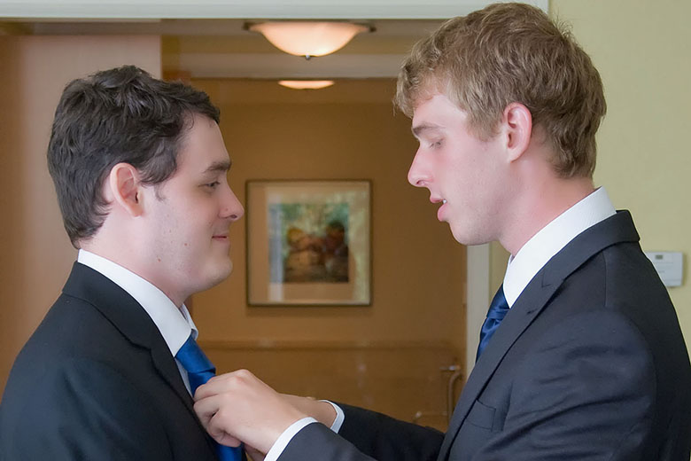 The groom is getting a little help from the best man