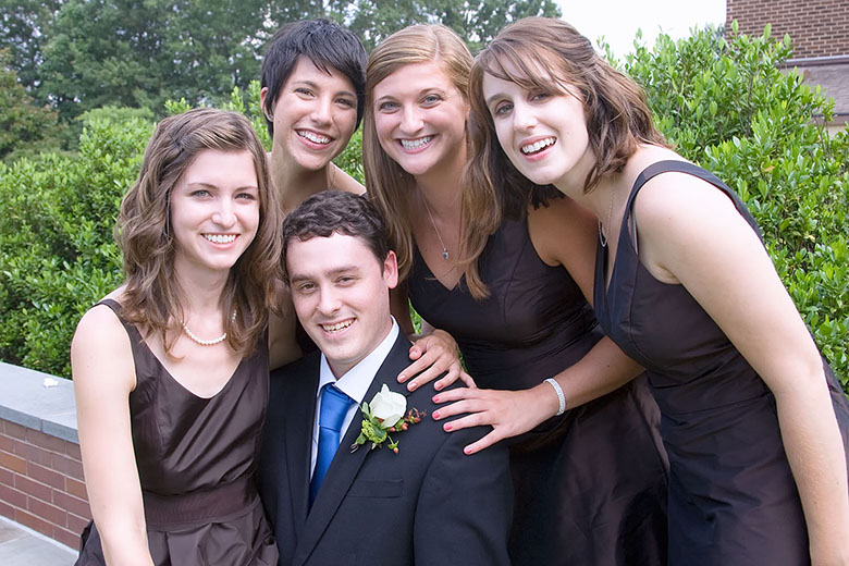 The groom with the maid of honor and the bridesmaids