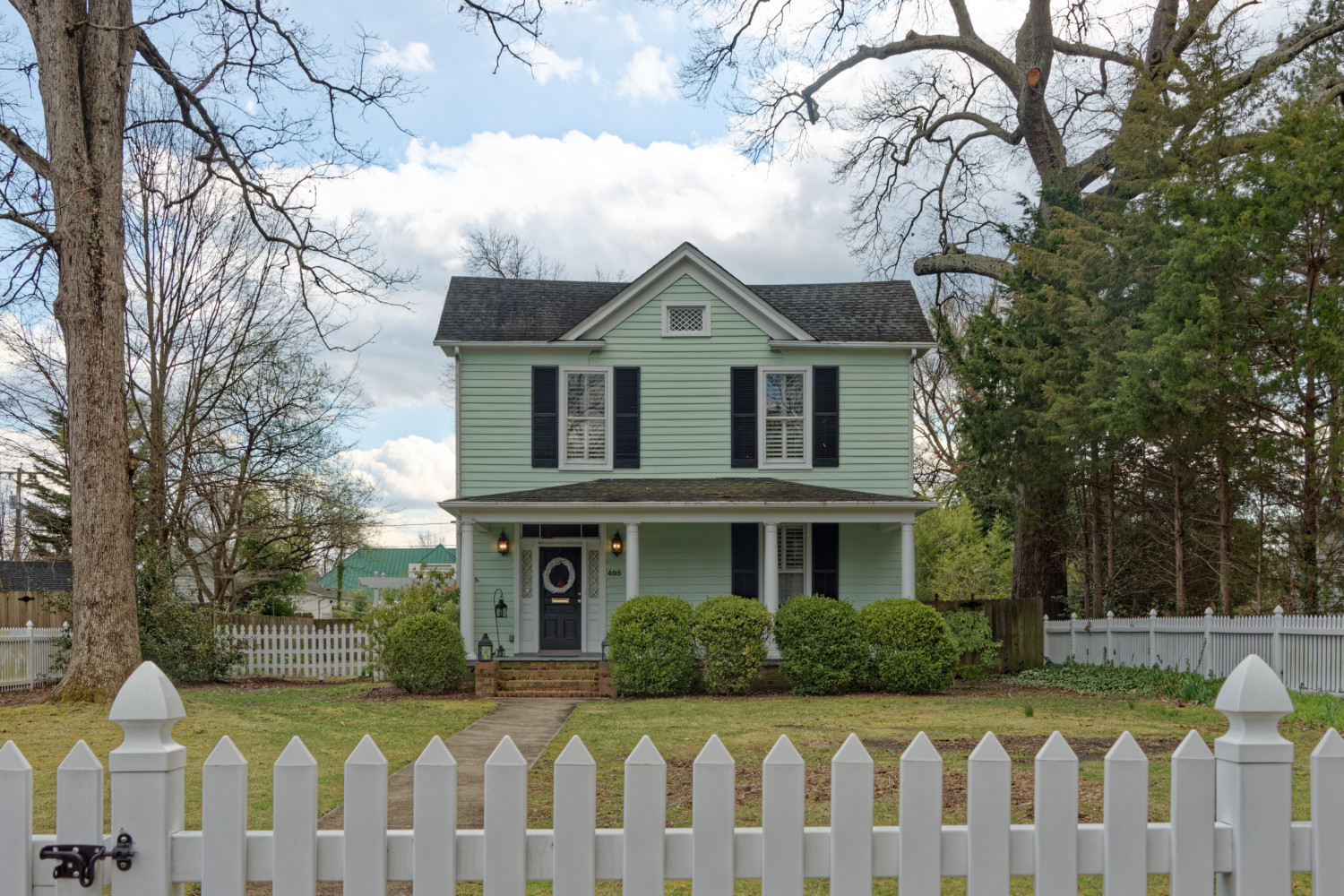 Residence with white fence