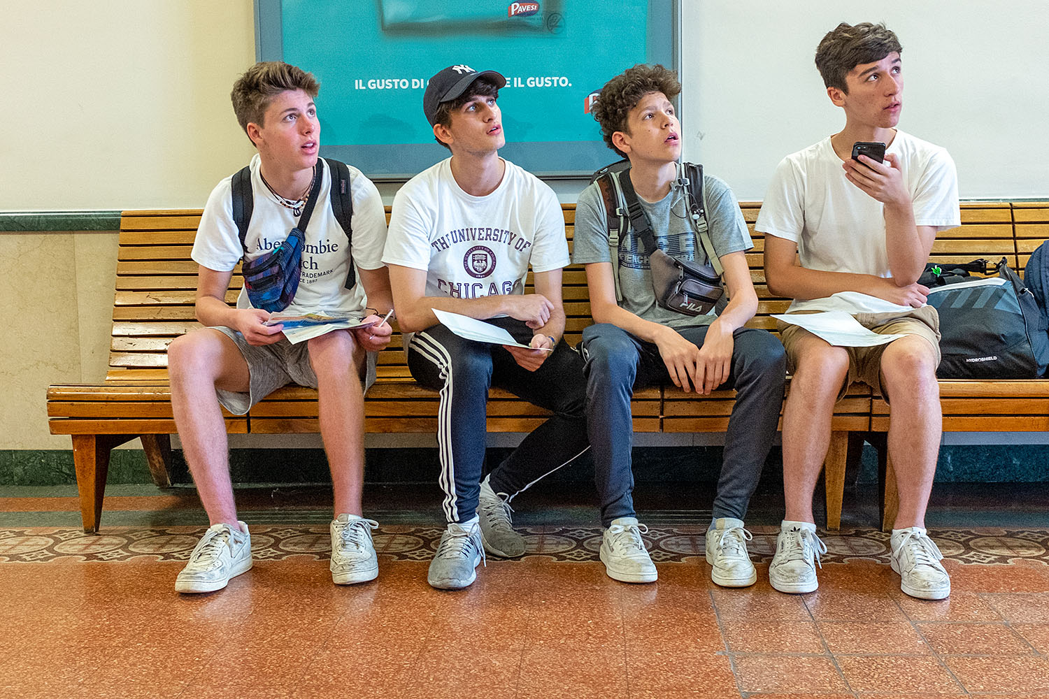 Group of young American travelers studying the departure board