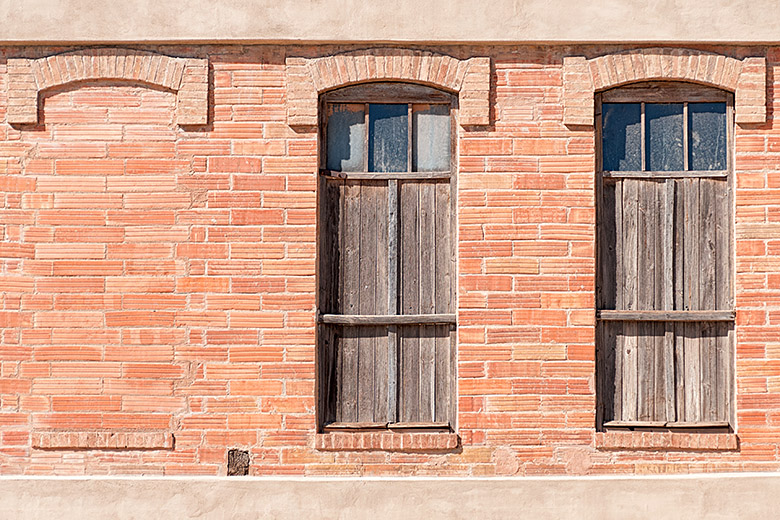 Most windows have been boarded or bricked up