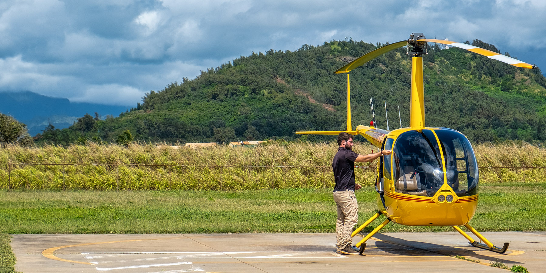 Jose, our pilot, is taking the doors off the R44 helicopter in preparation for our no-doors flight