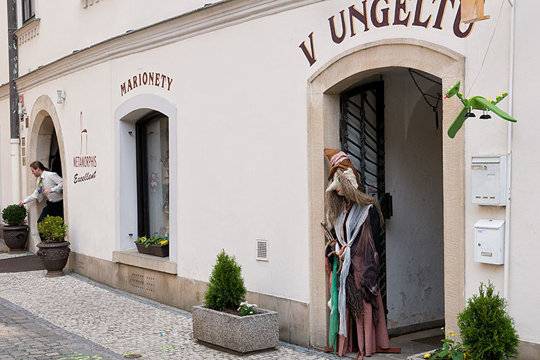 The hotel entrance to the left and the puppet shop to the right