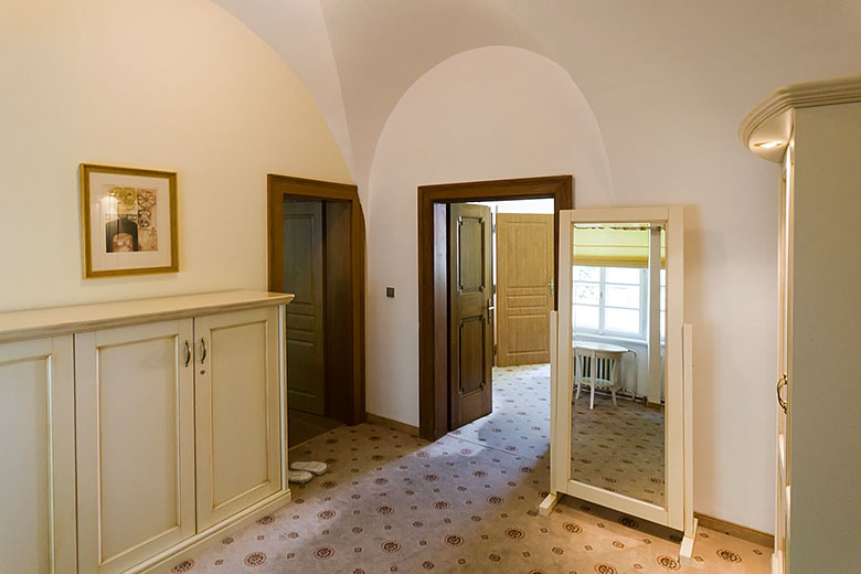 The entrance with doors leading to the bath and the living roon