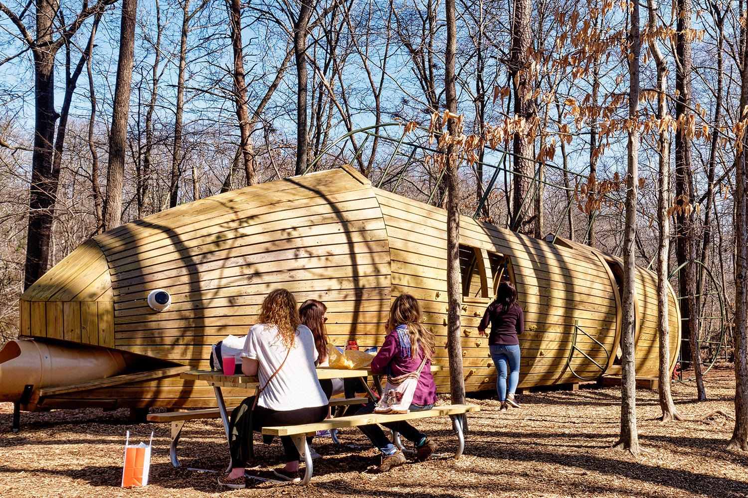 The huge wooden fish slide at the playground measures 45 feet and weighs six tons
